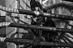 A woman crosses the border turnstiles. Moroccans have to go through narrow turnstiles and have to wait for hours. The border has not been designed for such a flow of people. Melilla. Spain